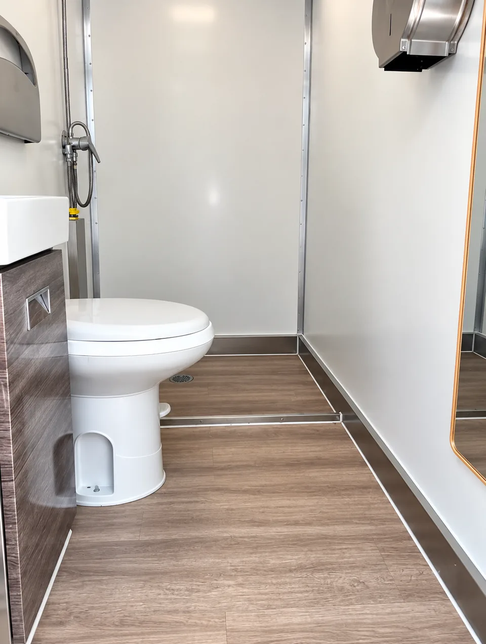 Bathroom interior in the 13 ft three-stall shower and restroom combination trailer